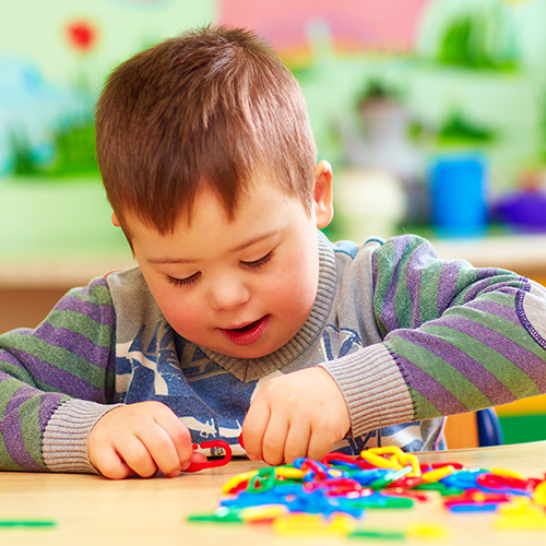 Child playing with toy links